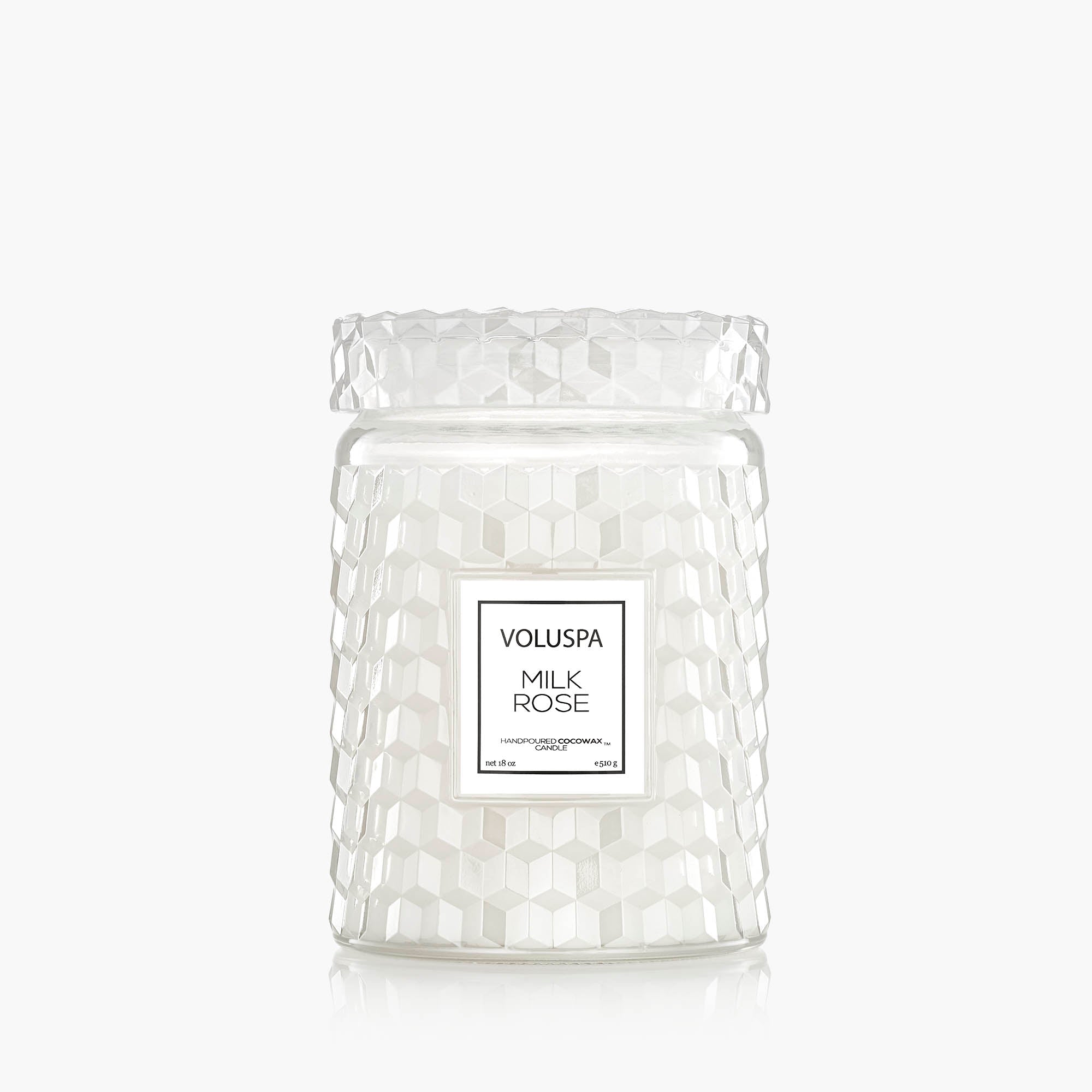 Clear glass candle jar with textured surface and Voluspa label on a white background