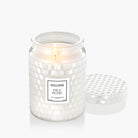 White Voluspa candle with 'Milk Rose' label on a white background