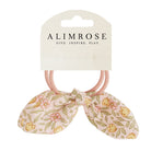 Two pink hair ties with floral bunny ear decorations.