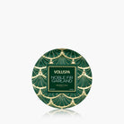 Voluspa Noble Fir Garland coconut wax in a round tin with a green and gold Art Deco pattern, shown on a light gray background with a reflection below.