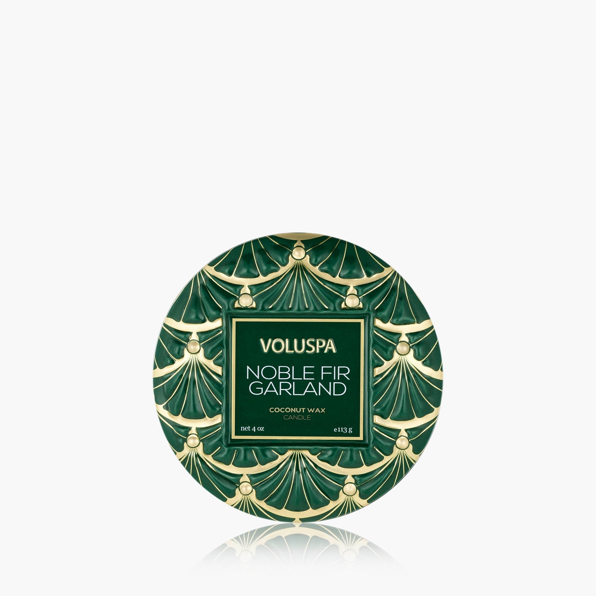 Voluspa Noble Fir Garland coconut wax in a round tin with a green and gold Art Deco pattern, shown on a light gray background with a reflection below.