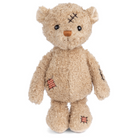 Stuffed teddy bear with bandages and stitches on a white background