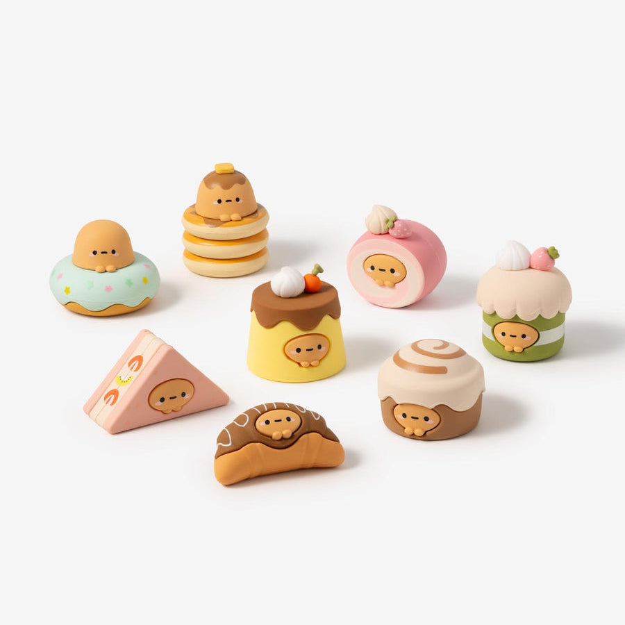 Set of colorful toy cakes on a white background
