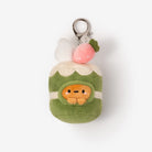 Plush keychain shaped like a green dumpling with a face on a white background