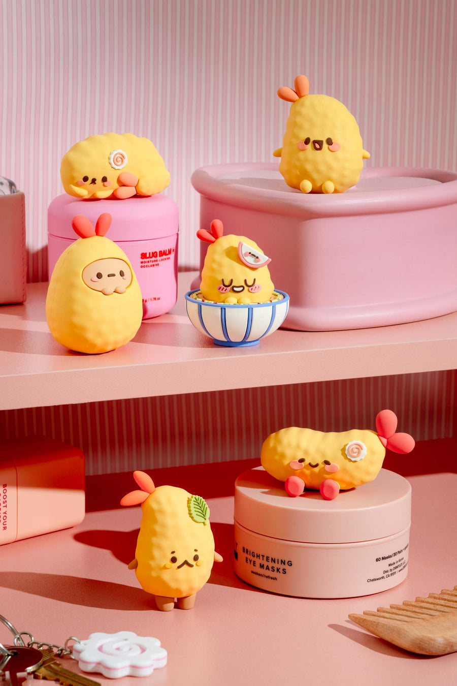 Yellow plush toys resembling lemons on pink shelves with cosmetic products.