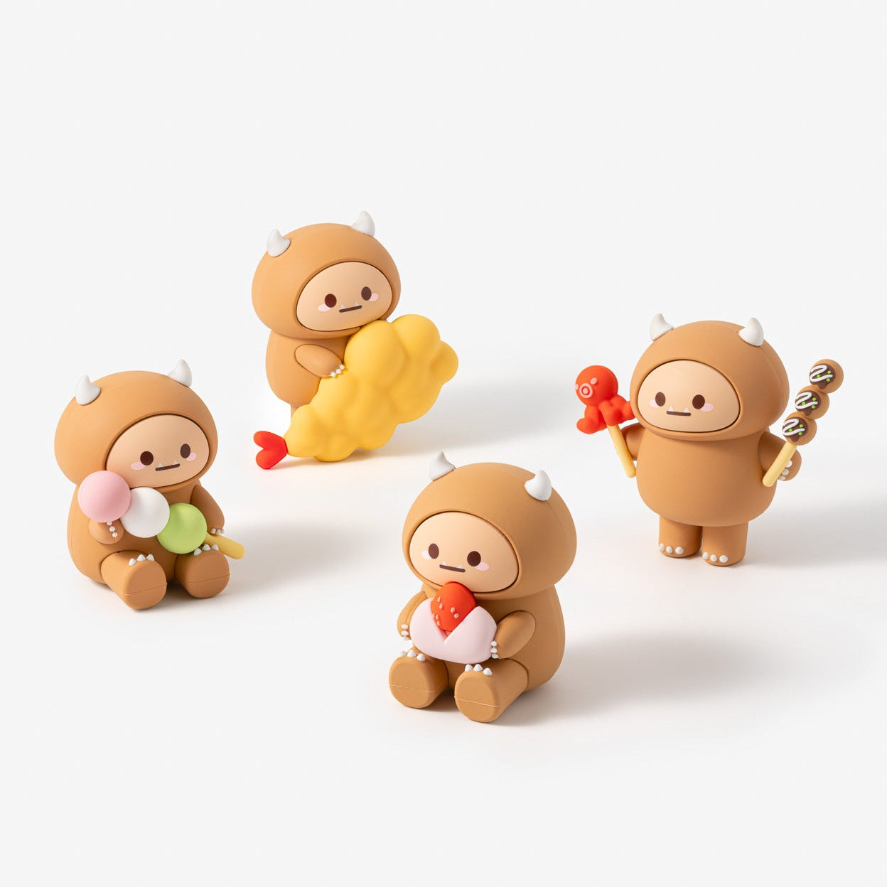 Four small figurines of a cartoon character in different poses on a white background