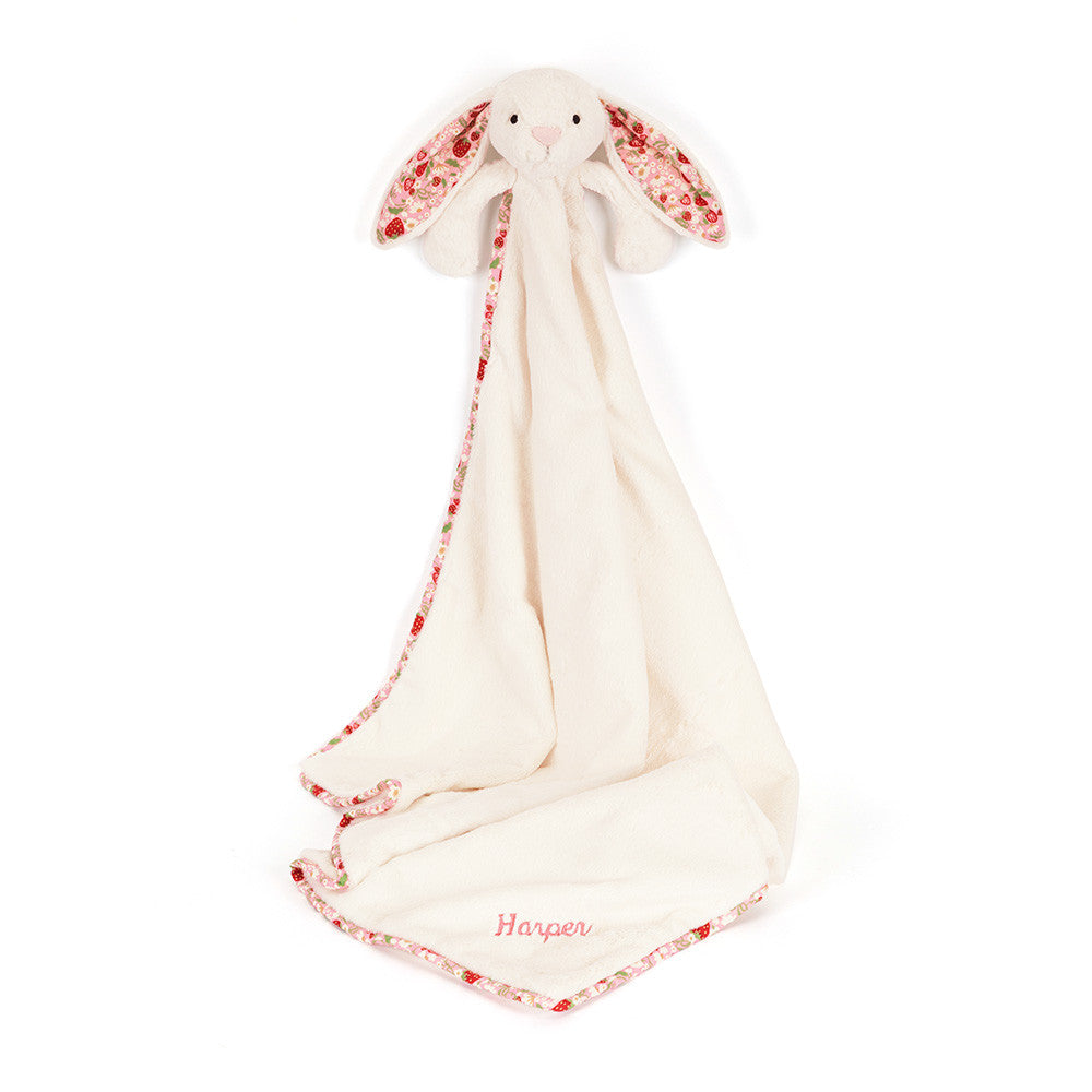 Stuffed white rabbit security blanket with strawberry pattern trim.

