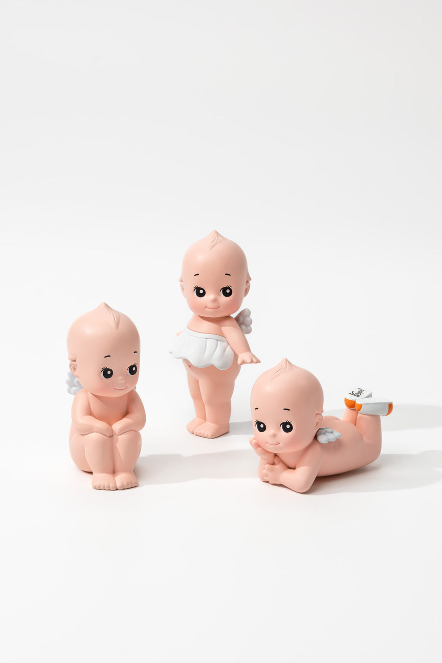 Small figurines of babies on a white background