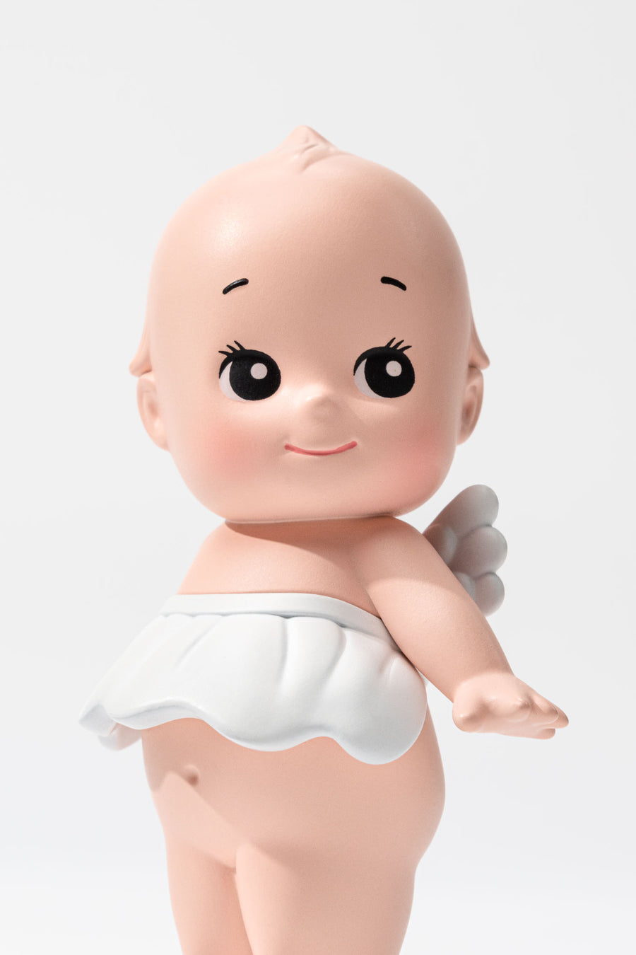Small figurine of a baby against a white background