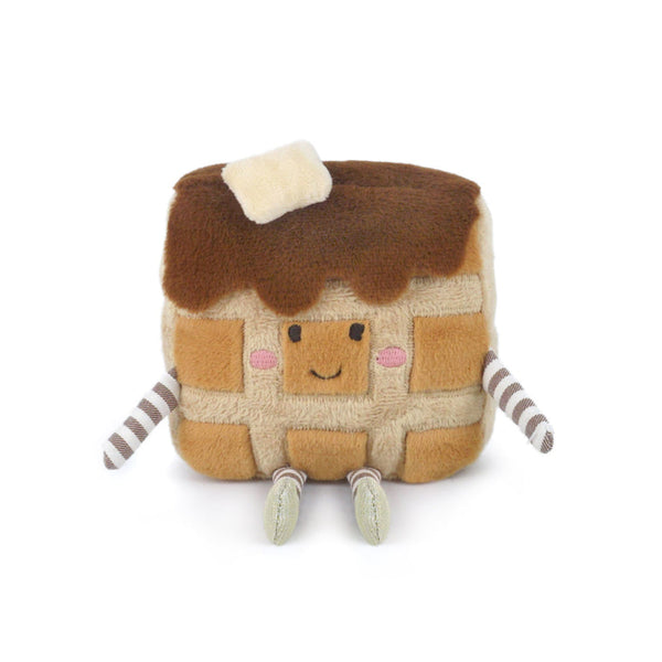 Stuffed square waffle with syrup, butter, face, arms, and legs.
