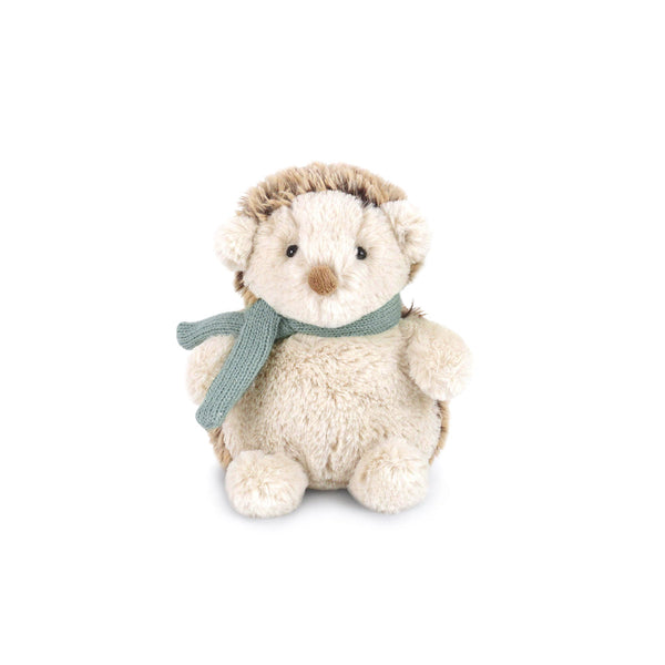 Stuffed hedgehog toy with green scarf.
