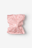 Pink diaper with white patterns on a light gray background