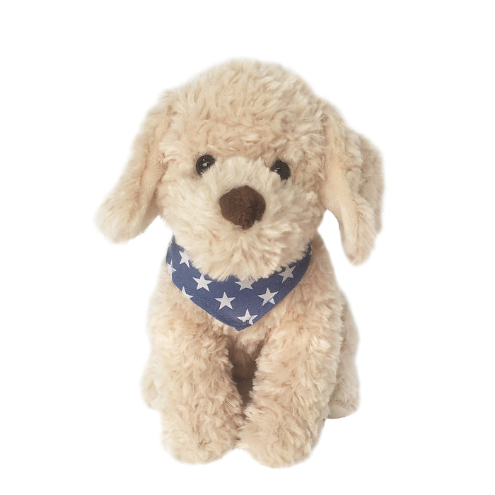 Tan stuffed dog wearing a blue bandana with white stars.
