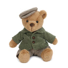 Stuffed teddy bear wearing a newsboy cap, corduroy jacket, and striped pants.
