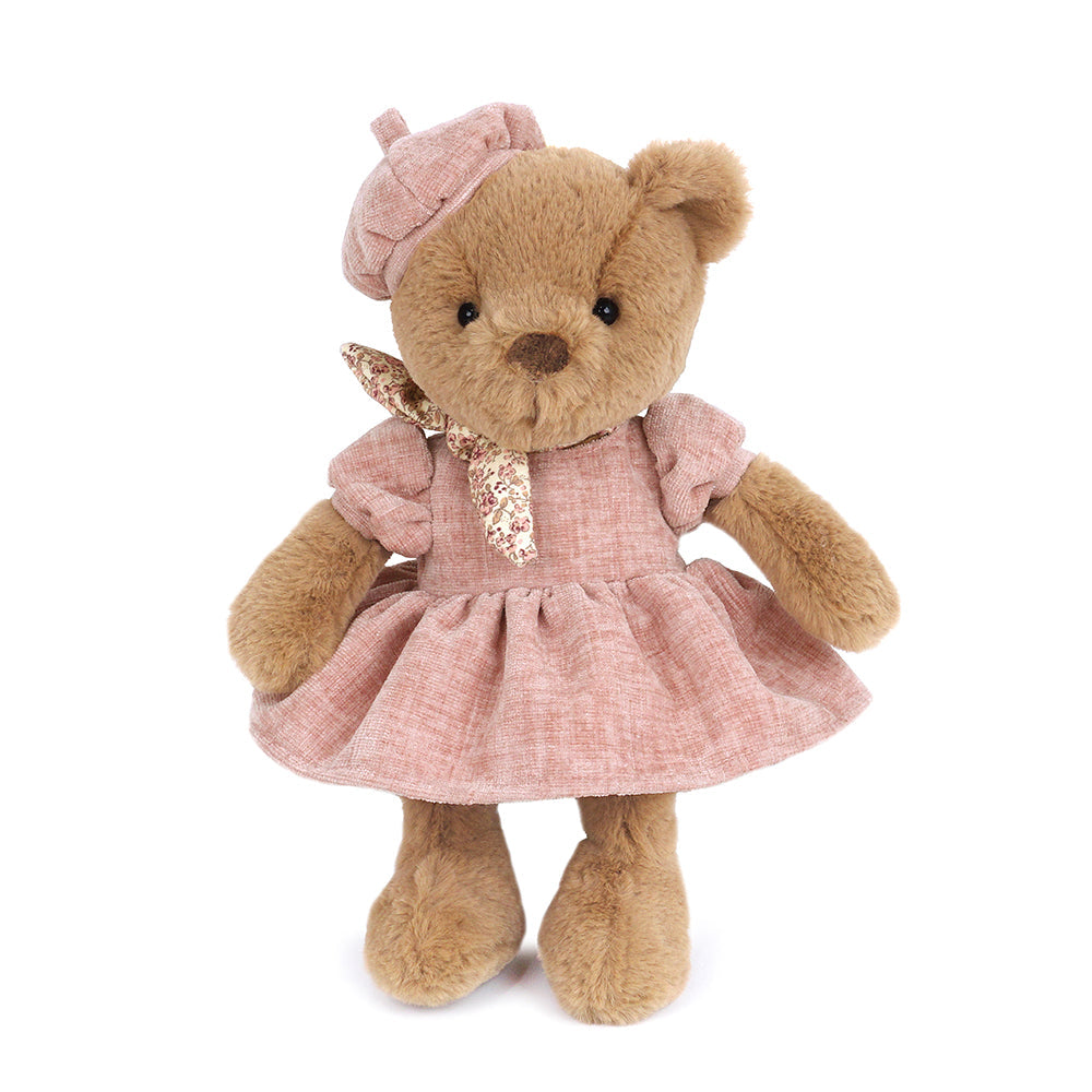 Stuffed bear wearing pink dress and beret.
