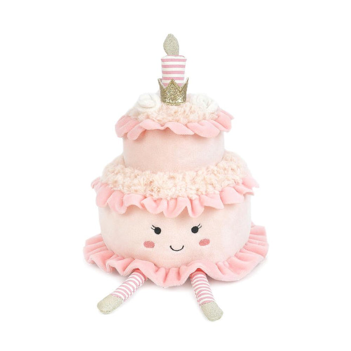 Plush toy shaped like a birthday cake with a face, on a white background
