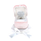 Pink plush toy with a white bow on a white background