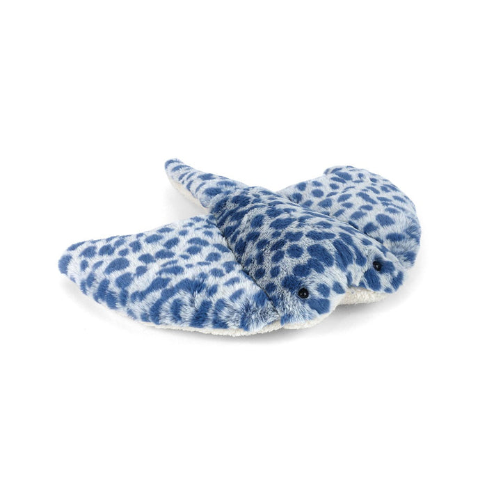Plush toy whale with blue and white pattern on a white background