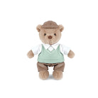 Stuffed teddy bear wearing a suit and hat on a white background