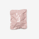 Pink crumpled paper bag on a white background