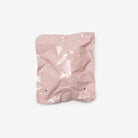 Pink crumpled paper bag on a white background