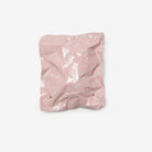 Pink crumpled paper bag on a white background