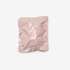 Pink crumpled paper bag on a white background