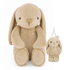 A beige plush bunny toy with long floppy ears, black bead eyes, and a small rhinestone chest ornament, shown next to a matching mini keychain with a silver metal clip.