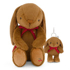 A large brown plush bunny toy with long floppy ears, a red ribbon bow, and embroidered cherries on its foot, shown next to a smaller matching plush keychain with a silver key ring on a white background.