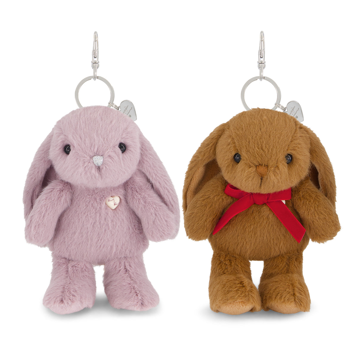 Two plush bunny keychains on a white background, one light pink with a silver heart pendant and the other brown with a red ribbon and silver heart pendant.