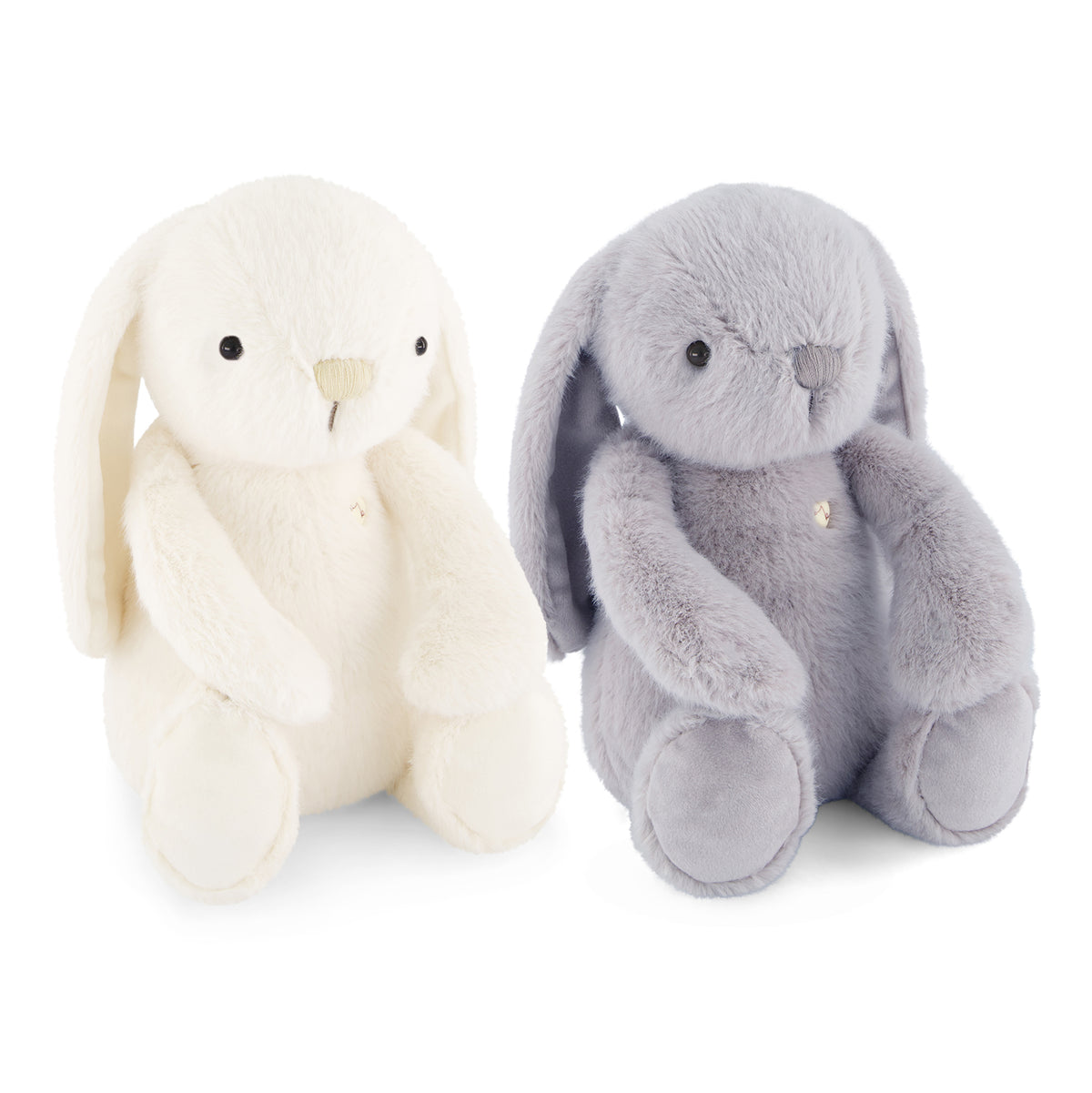 Two plush bunny toys on a white background, one cream white and one light gray, both with long floppy ears, black bead eyes, and small gold-tone bell accents.