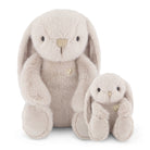 Two beige stuffed bunny rabbits sitting next to each other.