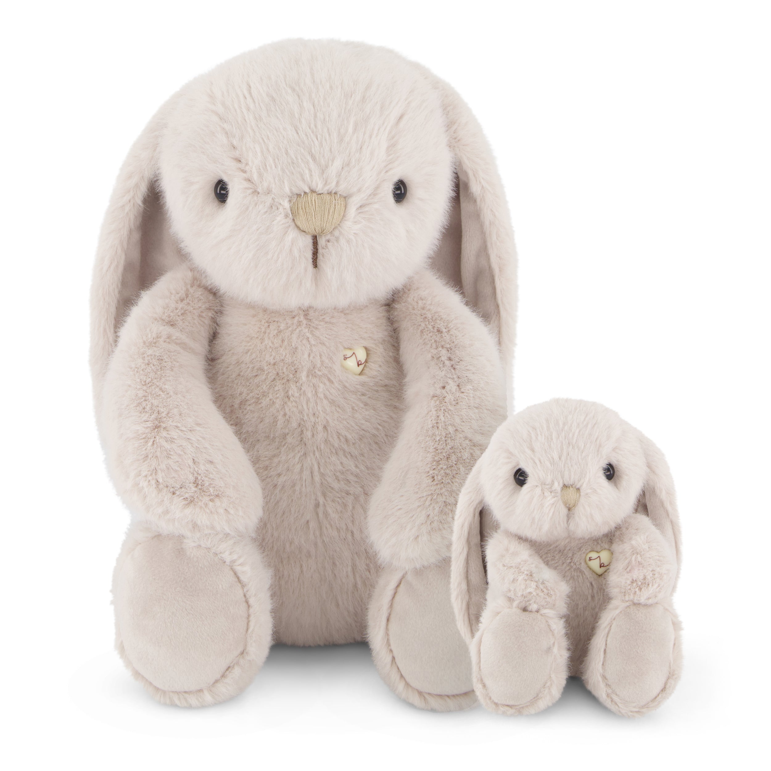 Two beige stuffed bunny rabbits sitting next to each other.