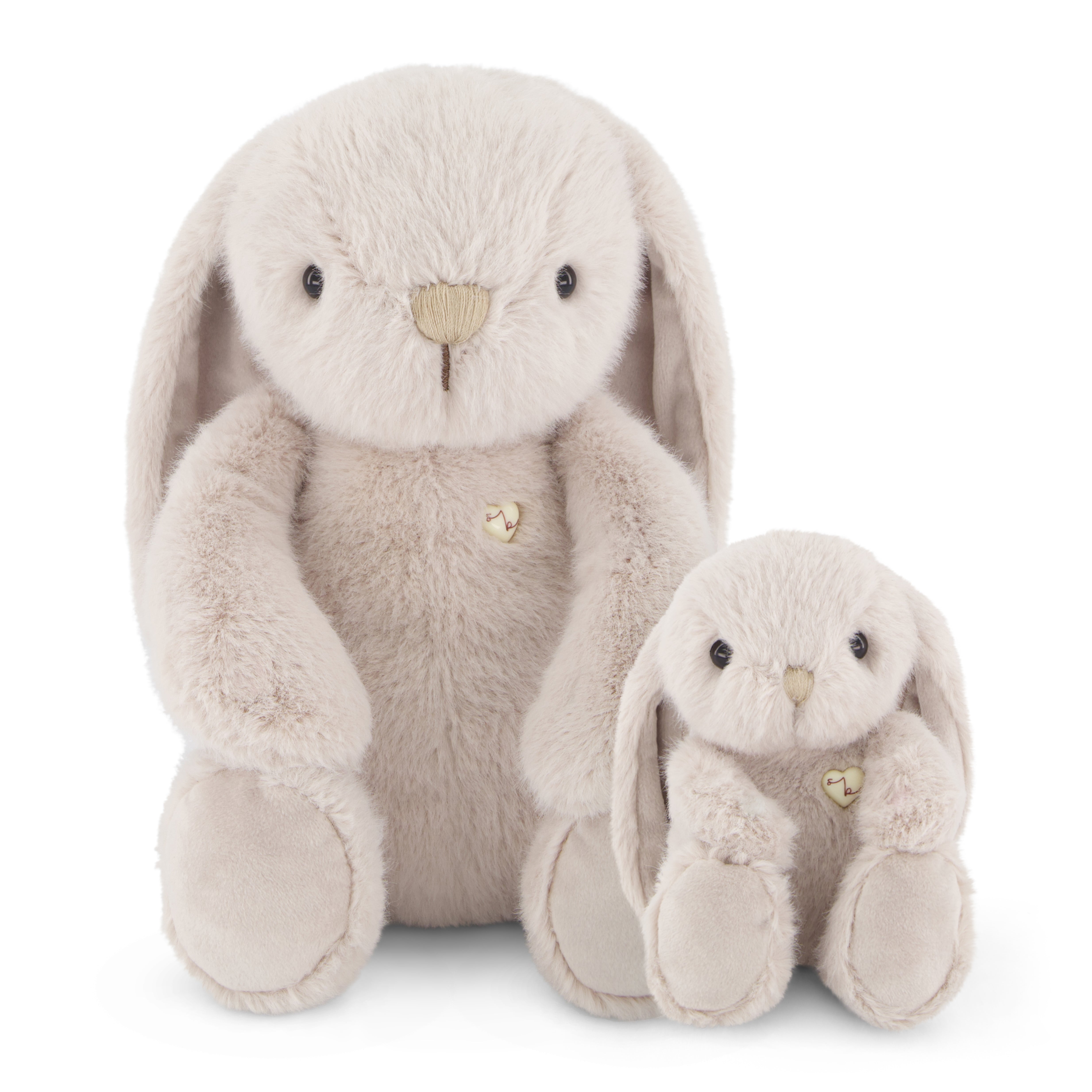 Two beige stuffed bunny rabbits sitting next to each other.