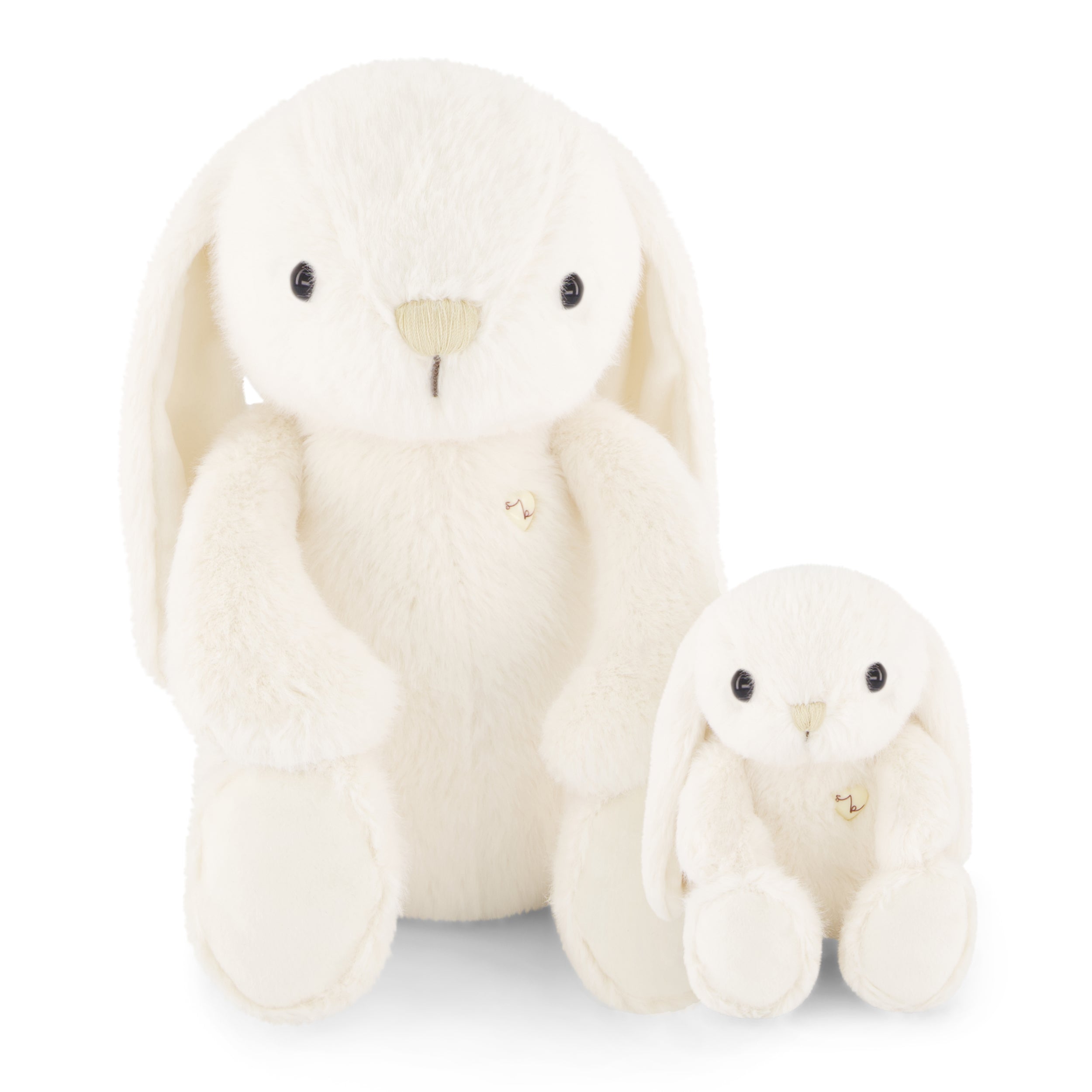 Two white stuffed bunny toys, one larger than the other, sitting next to each other.
