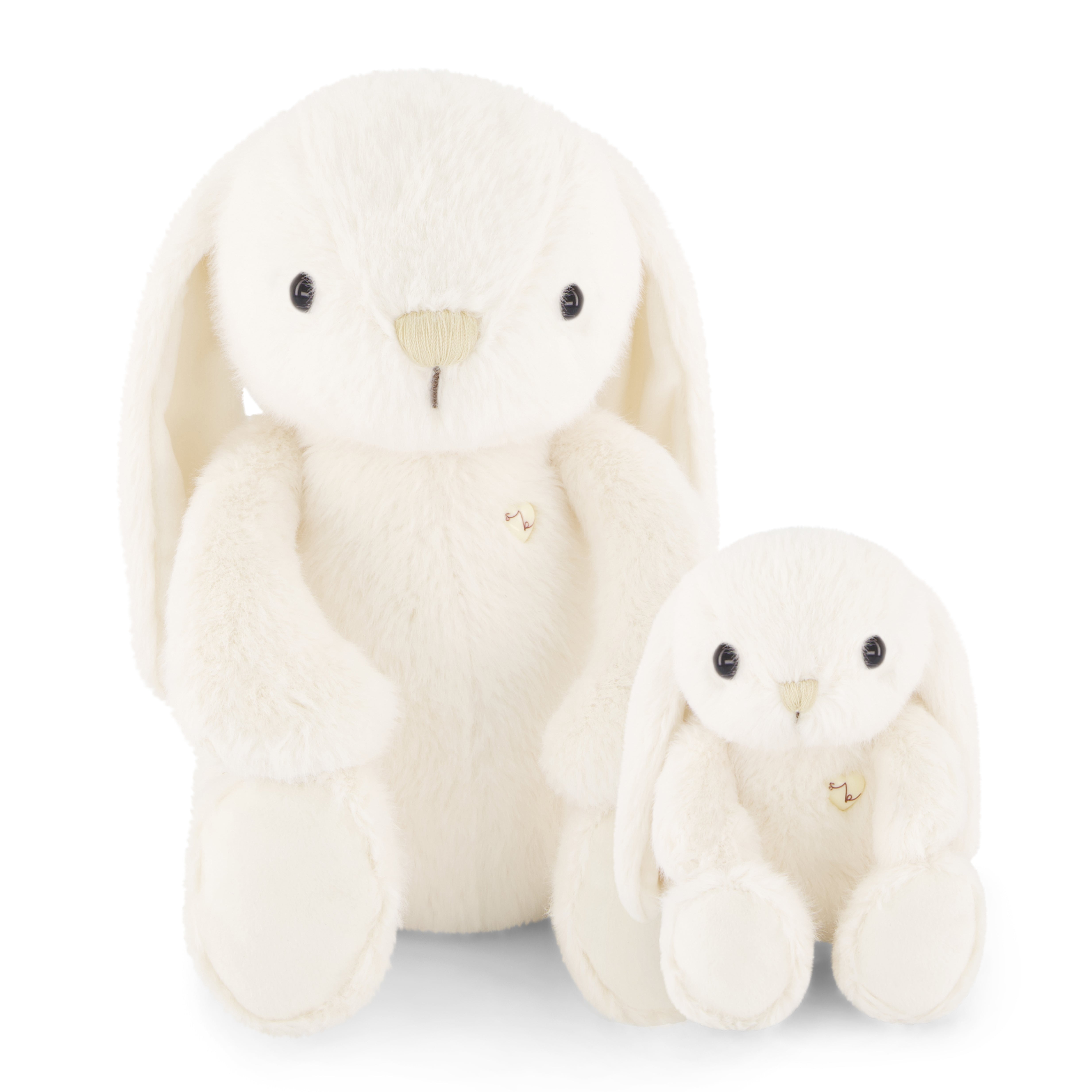 Two white stuffed bunny toys, one larger than the other, sitting next to each other.