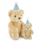 A plush teddy bear set featuring a large cream-colored teddy bear and a smaller matching teddy bear ornament, both wearing light blue party hats with white pom-poms and light blue ribbons, on a white background.