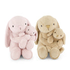 Two plush bunny dolls with soft fur, each holding a smaller bunny, shown side by side on a plain white background. One is light pink and the other is light beige/tan.