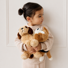 Soft tan and brown plush Shih Tzu dog toy by Snuggle Bunnies, held by child in beige sweater, side view, 9 inches tall