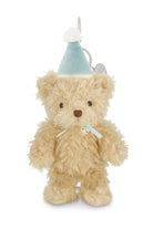 Plush teddy bear with a blue hat on a white background