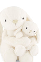 Two cream-colored plush toys, one larger and one smaller, on a white background.