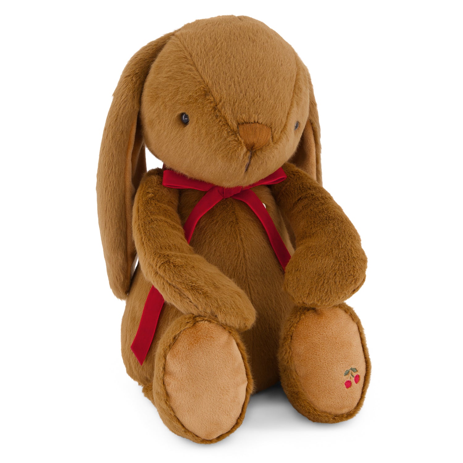 Brown plush bunny with a red bow tie on a white background