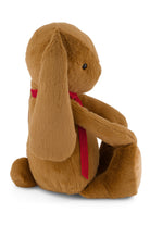 Brown plush bunny with a red bow tie on a white background