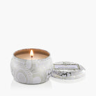 Candle in a decorative tin with a white background