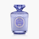 Decorative purple candle with intricate design and Voluspa branding on a white background