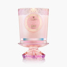 Pink candle with decorative design on a white background