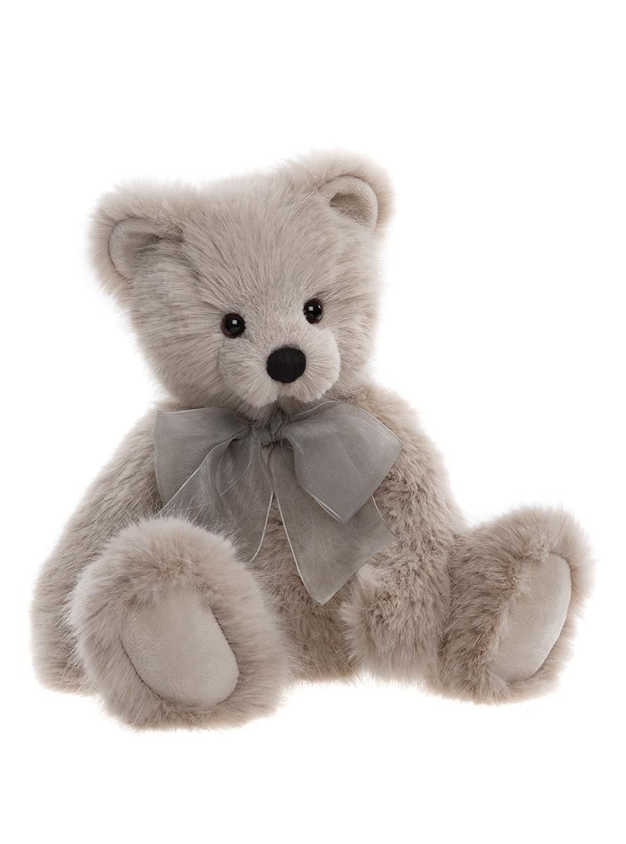 Plush teddy bear with a gray bow on a white background