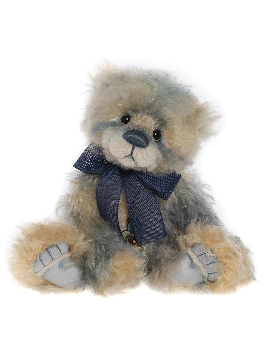 Stuffed teddy bear with a blue bow tie on a white background