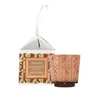 Voluspa Gingerbread Chalet coconut wax candle in a clear hanging box with a printed gingerbread-themed label, shown next to a small gingerbread-patterned candle holder on a white background.