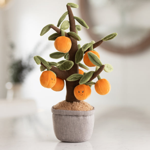 Plush toy tree with orange fruits on a blurred background